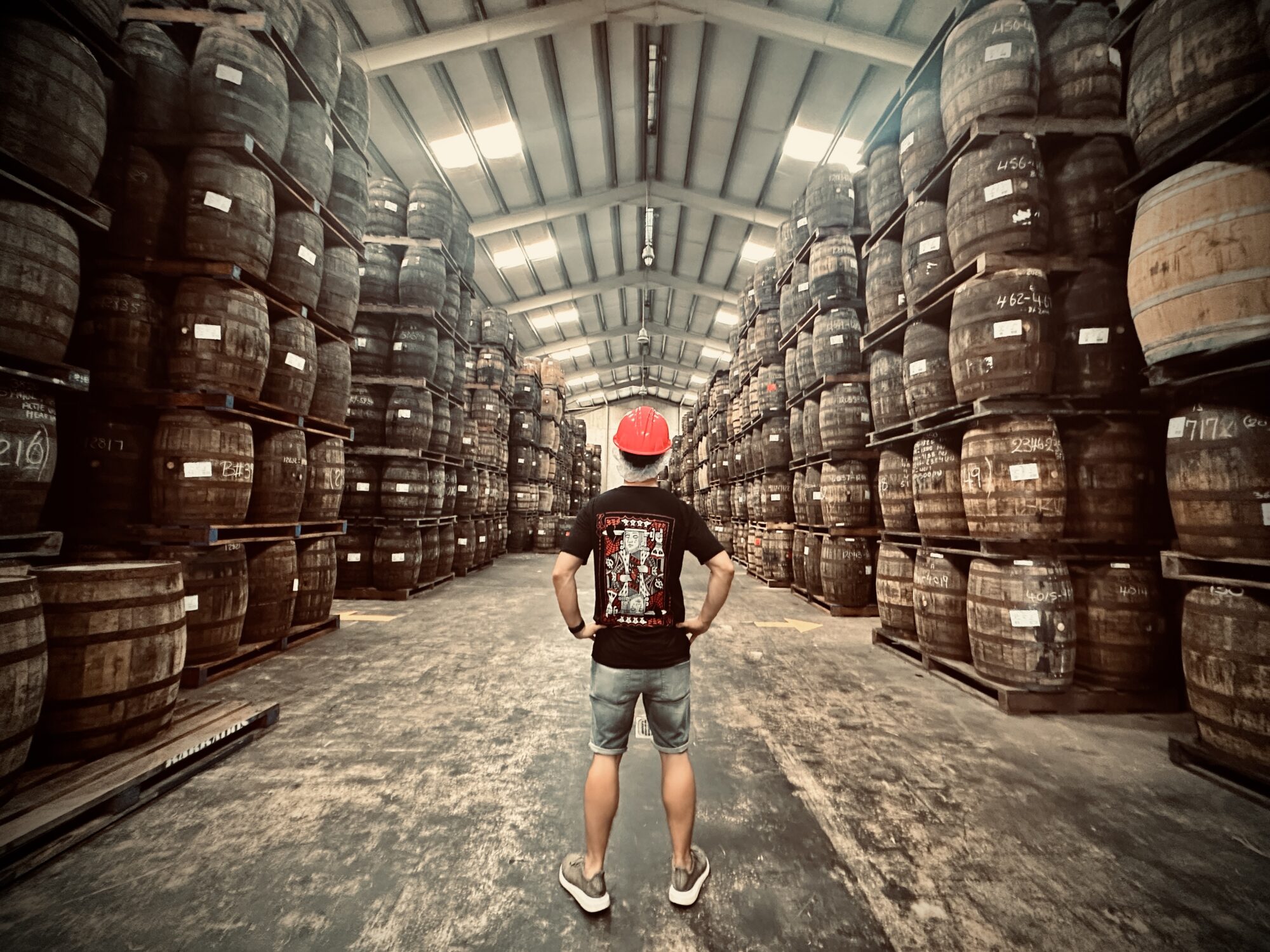 A Man in a maturation warehouse at Mount Rum Distillery.
