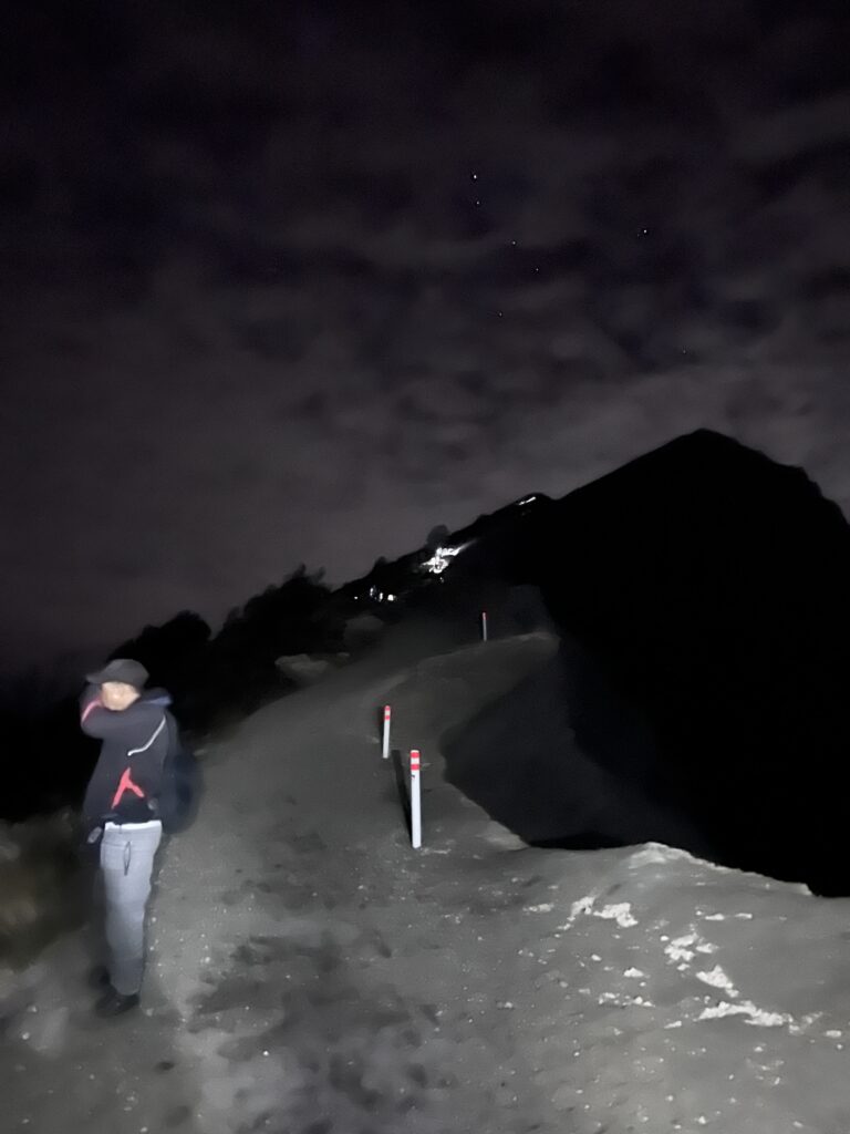 Hiking Mount Rinjani, Lombok. Hikers along the exposed upper volcanic ridge in the dark.